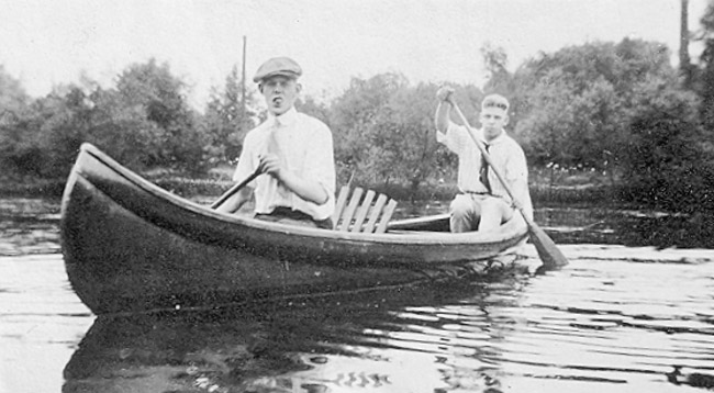 Two white men in canoe on the water