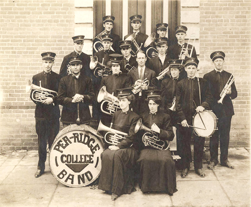 Group of young white men and women in uniforms with brass instruments and drums