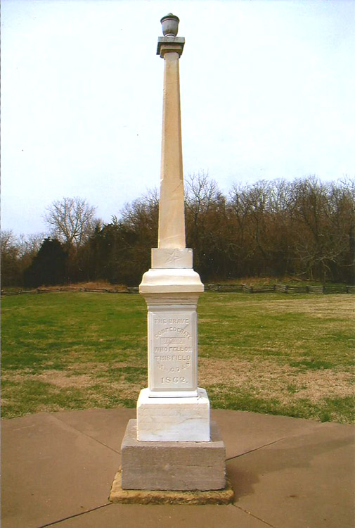 Urn on top of obelisk shaped monument with engraved base