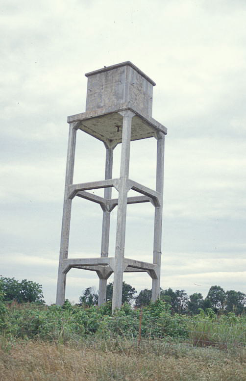 square concrete water tower in field