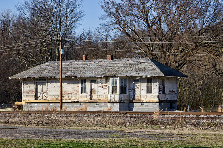 Abandoned train depot building with power lines