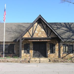 Single-story building with covered porch and stone walls