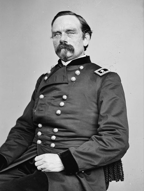 White man with mustache sitting in military uniform