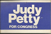 Blue and white campaign badge with "Judy Petty for Congress" in text