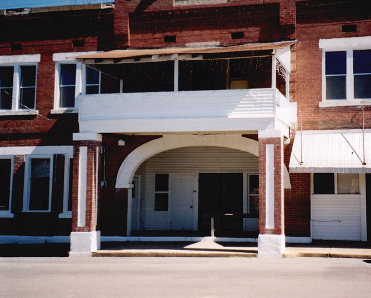 Close-up of multistory brick building with arched entrance