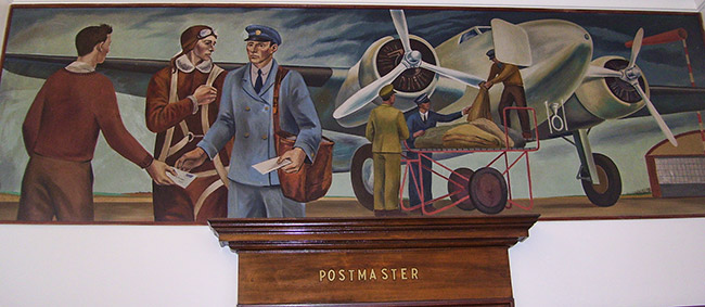 White workers and postman with airplane in painting above door marked "Postmaster"