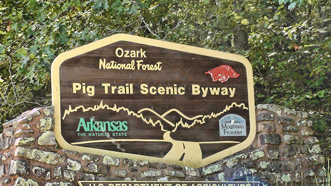 "Pig Trail Scenic Byway" sign with stone base