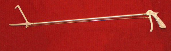 Gold grabber device on red background