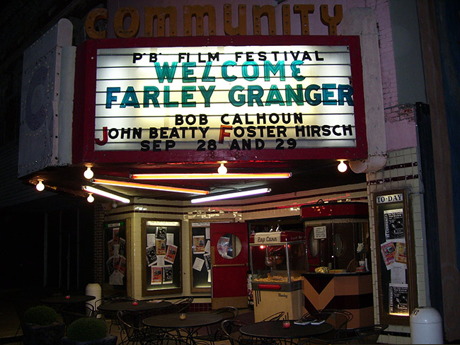 Theater building at night with "Welcome Farley Granger" on its marquee