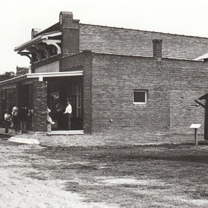 Brick building with people standing around in front