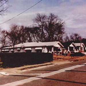 Row of carpenter style houses with covered porches on street