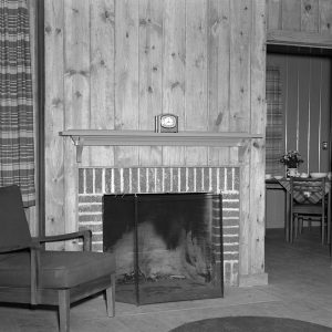 Interior of room with brick fireplace and furniture