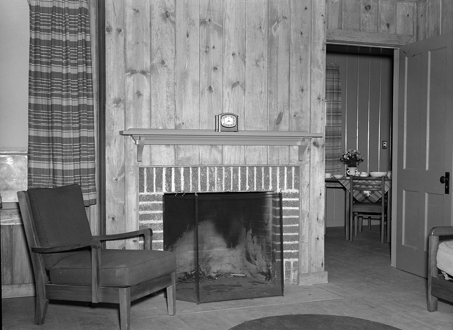 Interior of room with brick fireplace and furniture