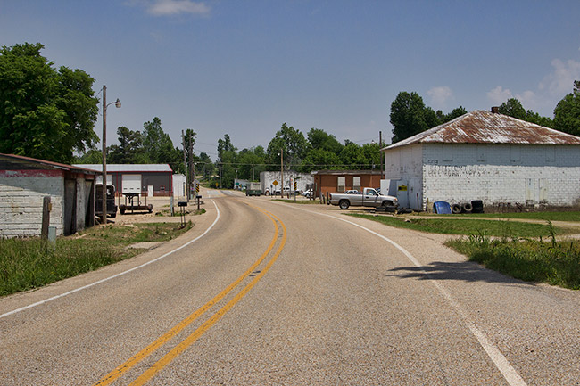 Garage buildings and brick building on two-lane road