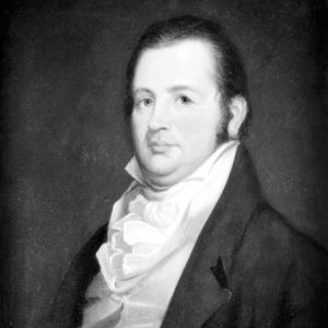 White man in unbuttoned suit jacket and cravat