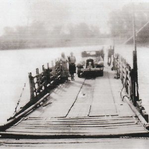 faded old photo of car and patrons on ferry platform
