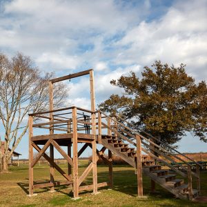Wooden gallows with stairs on grass