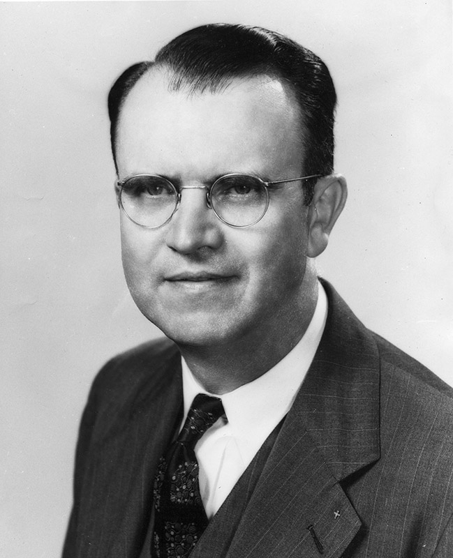 White man in wearing glasses in suit and tie