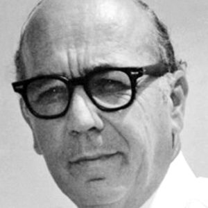 White man in black framed glasses in shirt and tie
