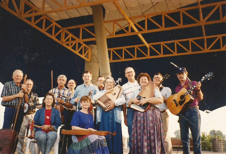 Group of white musicians with their instruments on outdoor stage
