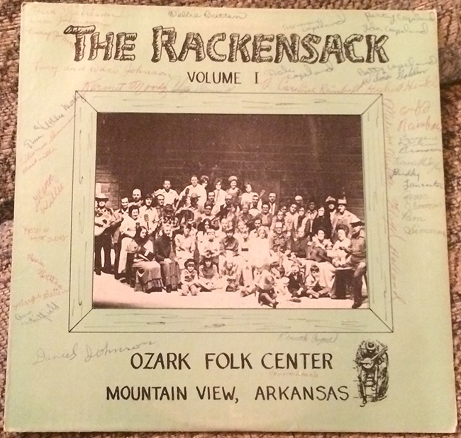 Group photograph of white musicians with their instruments on signed cover of "The Rackensack Volume 1" album
