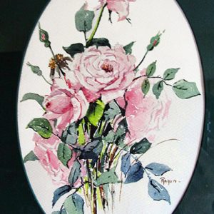 Pink roses with green leaves in oval shaped frame