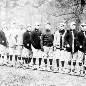 Group of white men in sports uniforms standing in line