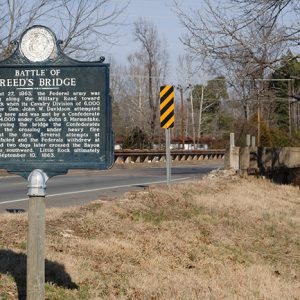 "Battle of Reed's Bridge" sign with highway bridge