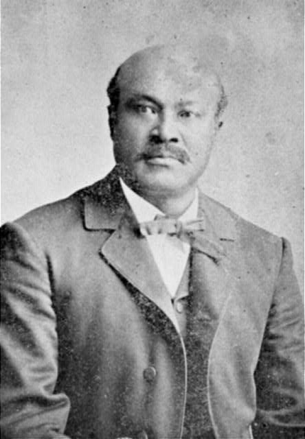 Bald African-American man in suit and bow tie