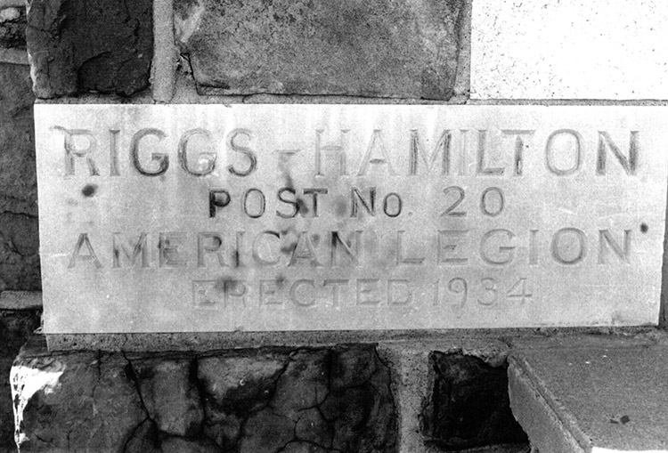 "Riggs Hamilton Post Number 20" engraved stone in brick wall