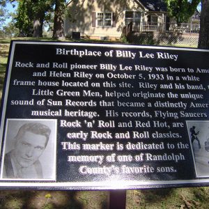 "Birthplace of Billy Lee Riley" plaque with photographs and house in the background