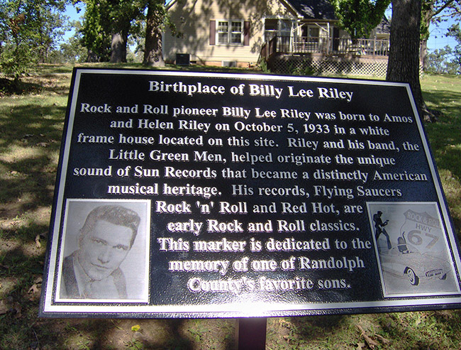 "Birthplace of Billy Lee Riley" plaque with photographs and house in the background