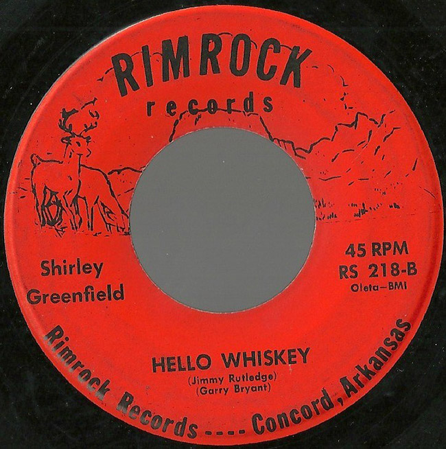 Close-up of vinyl record with red label and deer illustrations