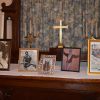 Pictures in frames on church altar with cross and candlesticks behind them