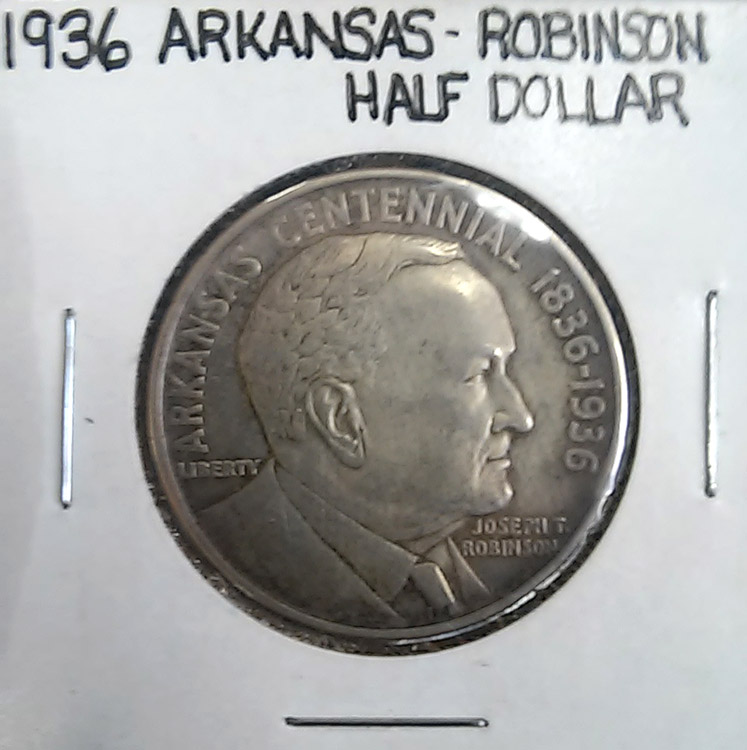Coin in coin sleeve with "Arkansas-Robinson Half Dollar" written on it