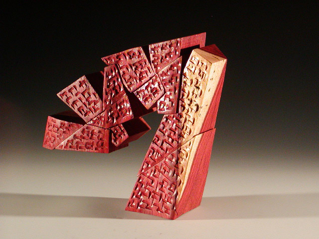 Balancing "A" formed wooden sculpture combining rhythmic jagged blocks emphasizing diagonal lines with gouged surface