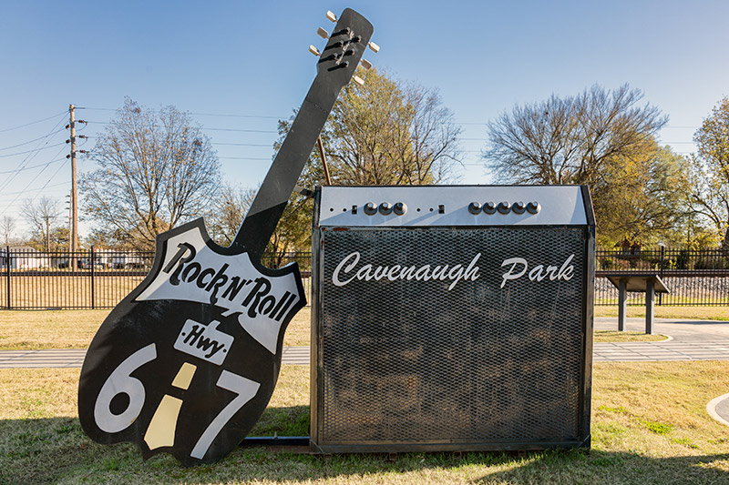 Giant guitar and amplifier shaped signs on grass