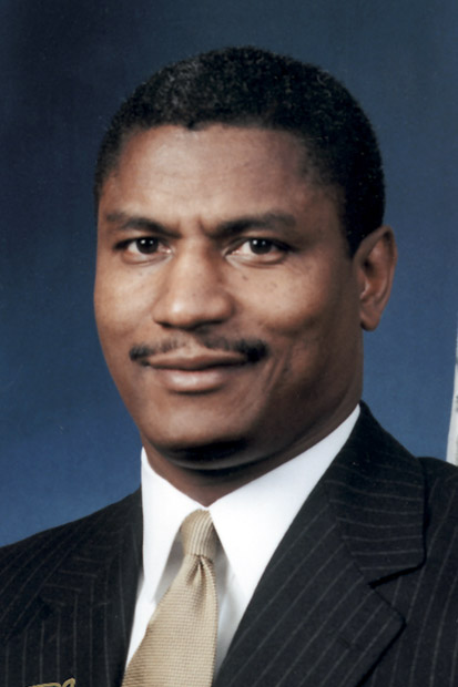 Portrait black man suit and tie smiling short hair blank photo backdrop