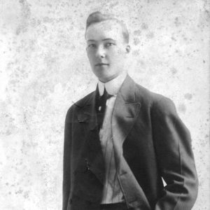 Young white man standing in suit and tie