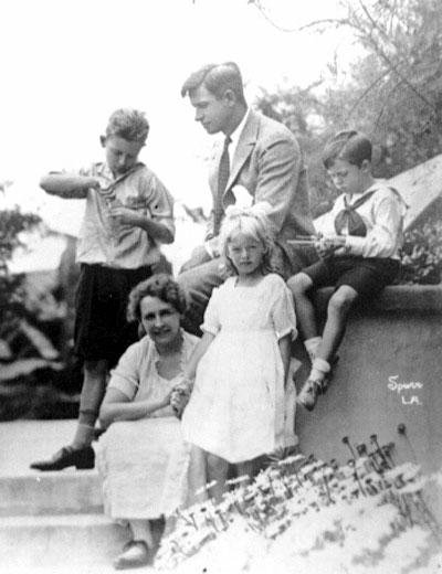 White man in suit with his wife, two sons, and daughter