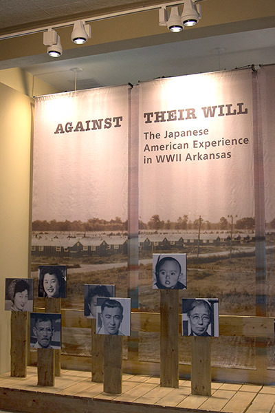 "Against their will the Japanese American Experience in World War Two Arkansas" display with photographs in museum