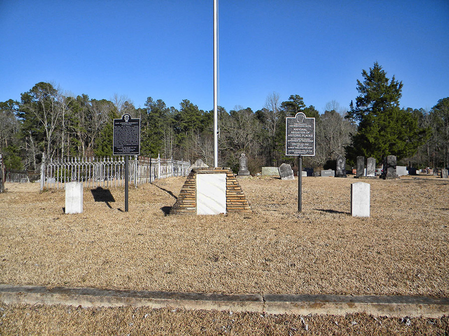 Flag pole with signs in cemetery