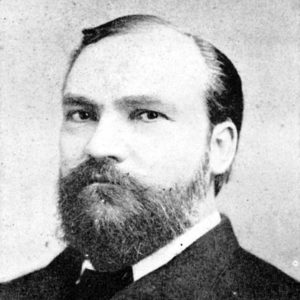 White man with full beard in suit and tie