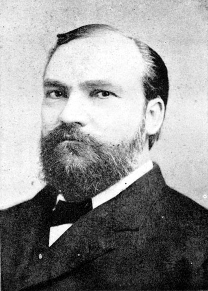 White man with full beard in suit and tie