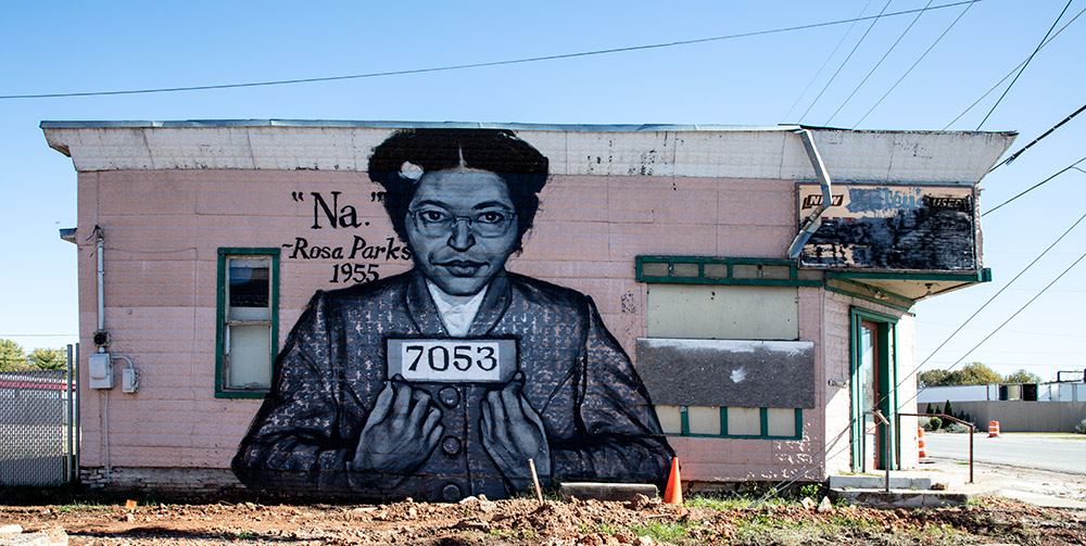 Mural featuring African American woman on a pink building