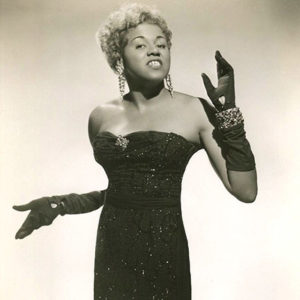 African-American woman in sparkly dress and long gloves