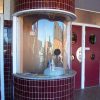 Round box office window with red tile walls