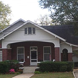 Single-story brick house with gabled roof and carport