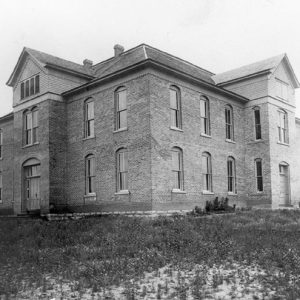 Two-story brick school building with square windows