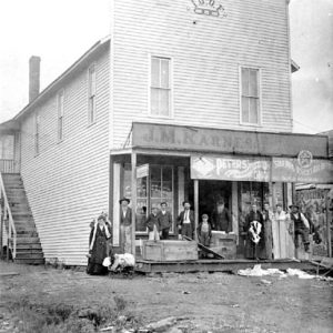 Two-story building with white people standing in front